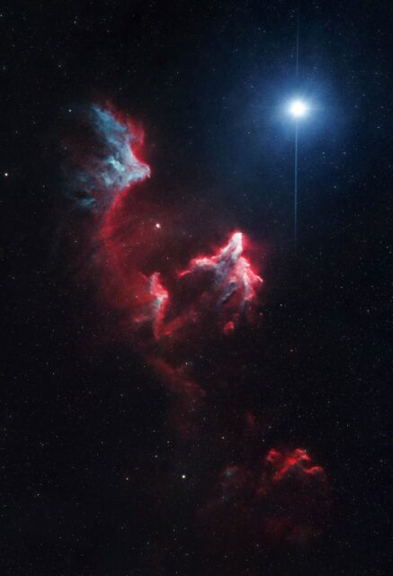Happy Spooky Season! I’ve been wanting to capture this one for a bit. It’s a reflection nebula with a strong hydrogen-alpha cloud called “The Ghost of Cassiopeia.” I shot the Ha data in Roy and did a broadband session out at Causey Reservoir with Jamie Freeman when she visited. It could likely use more integration time, but I think it came out well. This might be a good candidate to revisit with a monochrome camera. In any case, I actually like the starless version despite the remaining noise. I did a bit of work on the star to get rid of the strong halos, and ended up overlaying a flare I shot using my cell phone light on my Sony A7 IV with the DZOFilm Arcana 45mm 1.5X anamorphic lens. I like how the final image looks.

Target: Ghost of Cassiopeia
Constellation: Cassiopeia
Location: Roy, Utah, Bortle 7, and Causey Reservoir, Bortle 4
Camera: ZWO ASI2600MC Air
Mount: ZWO AM3
Scope: Askar 120APO w/ Flattener
Filter: Askar ColourMagic D1 (Ha/OIII) and Luminance (clear)
Lights: D1 - 104 x 300 sec, Gain: 100, Cooling: -10°C
  L: 36 x 300 sec, Gain 100, Cooling -20°C
60x Flats, Flat-Darks, Darks
Total Integration Time: 11 hrs 40 min
Stacked in Pixinsight with BlurXTerminator, StarXTerminator, NoiseXTerminator
Finished in Photoshop