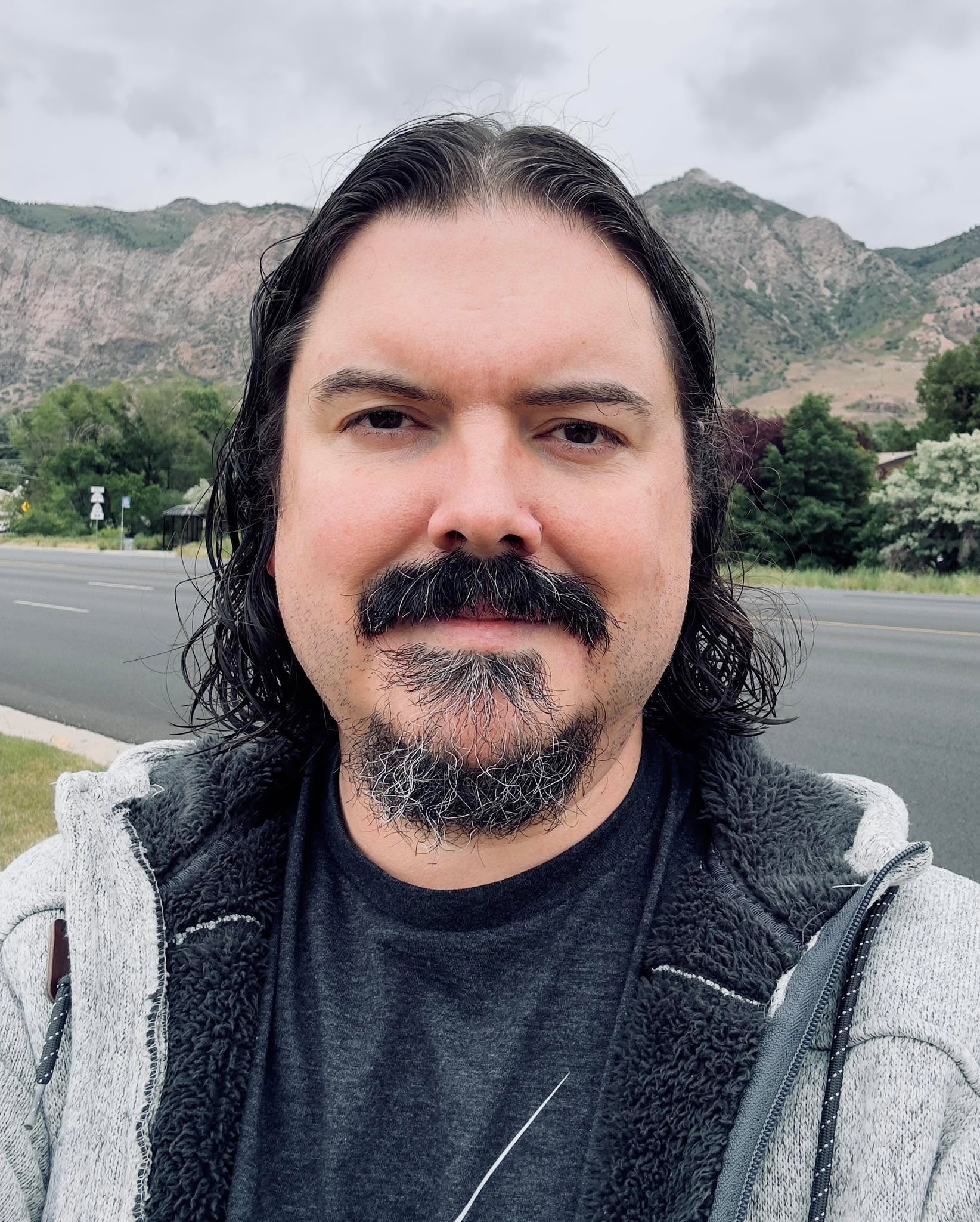 Just had a great haircut by Amber Lee Bridenstine. She showed me how to do a down/curly look. I might mix it up and do that once in a while, but I’ll probably still tie it back most of the time. Still, if you’re in the Ogden area, and looking for an LGBT-affirming hair stylist (she does coloring and other stuff too), she’s good peeps. Still debating if I want to do something adventurous for pride month this year, like rainbow tips…
